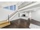 Open-concept living room with soaring ceilings, stairs, and hardwood floors leading to the kitchen at 4779 White Rock Cir # B, Boulder, CO 80301