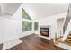 Inviting living room with a cozy fireplace, hardwood floors, and a large window for natural light at 4779 White Rock Cir # B, Boulder, CO 80301