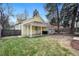 Landscaped backyard features a covered patio area with a detached office and mature trees at 3333 W Hayward Pl, Denver, CO 80211