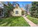 Inviting front yard showcases a cozy home with lush lawn and a stone path to the entrance at 3333 W Hayward Pl, Denver, CO 80211