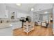 Charming kitchen featuring white cabinets, an island, and stainless steel appliances at 3333 W Hayward Pl, Denver, CO 80211