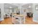 Open-concept kitchen with island, hardwood floors, and seamless flow to the dining and living areas at 3333 W Hayward Pl, Denver, CO 80211