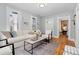 Inviting living room featuring hardwood floors, comfortable seating, and an abundance of natural light at 3333 W Hayward Pl, Denver, CO 80211