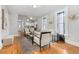 Cozy living area boasts hardwood floors, stylish furnishings, and an open flow to the kitchen at 3333 W Hayward Pl, Denver, CO 80211