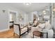 Bright living room with hardwood floors, neutral decor, and an open layout connecting to the kitchen at 3333 W Hayward Pl, Denver, CO 80211