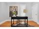 The office is adorned with a modern desk, a floral tapestry, and a hide rug at 3333 W Hayward Pl, Denver, CO 80211