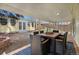 Covered patio features a stone floor, seating for six, and a view of the backyard and detached office at 3333 W Hayward Pl, Denver, CO 80211