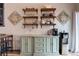 Dining area with wooden shelves, bar stool seating, and a buffet with a coffeemaker and water cooler at 3943 S Espana St, Aurora, CO 80013