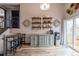 Dining area featuring stylish shelves, a staircase, and lots of natural light from sliding doors at 3943 S Espana St, Aurora, CO 80013