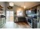 Modern kitchen with stainless steel appliances, stylish cabinets, and lots of natural light at 3943 S Espana St, Aurora, CO 80013