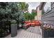 Relaxing back deck area with outdoor seating, lush plants, and beautiful backyard views at 9758 Red Oakes Dr, Highlands Ranch, CO 80126