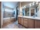 Spacious bathroom with double vanity, tub with stone surround, and a separate shower at 9758 Red Oakes Dr, Highlands Ranch, CO 80126