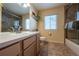 Tiled bathroom with neutral walls, a single sink vanity, toilet, and a shower behind glass at 9758 Red Oakes Dr, Highlands Ranch, CO 80126