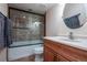 Bathroom with a shower over tub, modern tiling, large glass doors, and a vessel sink at 9758 Red Oakes Dr, Highlands Ranch, CO 80126