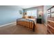 Comfortable bedroom with blue walls, natural light, and minimalist decor at 9758 Red Oakes Dr, Highlands Ranch, CO 80126
