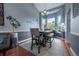 Elegant dining room featuring a modern chandelier, bay windows, and stylish decor at 9758 Red Oakes Dr, Highlands Ranch, CO 80126