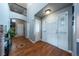 Bright foyer features hardwood floors, white trim, an arched doorway, and a view of the home's upper level at 9758 Red Oakes Dr, Highlands Ranch, CO 80126