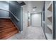 Hallway with tiled flooring, stairs, and convenient closet storage at 9758 Red Oakes Dr, Highlands Ranch, CO 80126