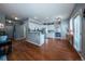 Open-concept kitchen features white cabinets, stainless steel appliances, and a breakfast bar that connects to the dining area at 9758 Red Oakes Dr, Highlands Ranch, CO 80126
