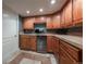 Finished basement kitchenette with wood cabinets, stainless appliances, and ample counter space at 9758 Red Oakes Dr, Highlands Ranch, CO 80126