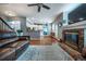 Cozy living room with a stone fireplace, hardwood floors, and open floor plan at 9758 Red Oakes Dr, Highlands Ranch, CO 80126
