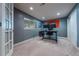 A well lit office featuring a large desk with multiple monitors and windows to allow natural light in at 9758 Red Oakes Dr, Highlands Ranch, CO 80126