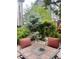 Outdoor patio area with a cozy seating around a fire pit table, enhanced by lush green plants at 9758 Red Oakes Dr, Highlands Ranch, CO 80126