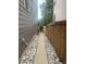 Narrow side yard with concrete pathway and decorative rock landscaping for low maintenance appeal at 9758 Red Oakes Dr, Highlands Ranch, CO 80126