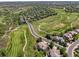 Expansive aerial view of golf course community with lush green fairways, mature trees, and elegant homes at 8864 S Quemoy Ct, Aurora, CO 80016
