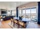 Bright dining area with outside views. Includes an oval table, rug, and modern lighting at 8864 S Quemoy Ct, Aurora, CO 80016