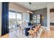 Dining room with sliding glass doors and modern light fixture at 8864 S Quemoy Ct, Aurora, CO 80016