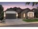 Charming single-Gathering home showcasing stone and siding, a two-car garage, and professionally landscaped grounds at 8864 S Quemoy Ct, Aurora, CO 80016