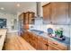 Well-lit kitchen with stainless steel appliances and wood cabinets at 8864 S Quemoy Ct, Aurora, CO 80016