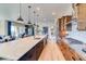 Modern kitchen featuring stainless steel appliances, an oversized island, and an open layout to the dining area at 8864 S Quemoy Ct, Aurora, CO 80016