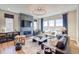 Comfortable living room with a fireplace, large windows, and stylish furnishings at 8864 S Quemoy Ct, Aurora, CO 80016