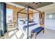 Comfortable main bedroom with wood accent wall and natural light at 8864 S Quemoy Ct, Aurora, CO 80016