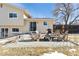 Inviting backyard patio with comfortable seating around a fire pit and a barbecue grill at 4879 S Xenophon St, Morrison, CO 80465