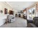 Living room featuring a desk area, sliding glass doors, a gray sofa, chair, and tan carpet at 4879 S Xenophon St, Morrison, CO 80465