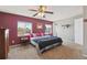 Inviting bedroom with cozy carpet, a ceiling fan, and bright windows at 4879 S Xenophon St, Morrison, CO 80465