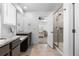 Bright bathroom features dual sinks with granite countertops, and a glass-enclosed shower at 1168 Elbridge Dr, Elizabeth, CO 80107