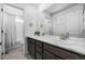 Bathroom featuring double sinks, white marble countertops, and a large mirror at 1168 Elbridge Dr, Elizabeth, CO 80107