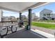 Relax on the covered patio, complete with a grill, dining table, and stylish outdoor rug, overlooking the green space at 1168 Elbridge Dr, Elizabeth, CO 80107