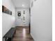 Hallway features wood flooring, white walls, and a modern bench at 1168 Elbridge Dr, Elizabeth, CO 80107