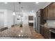 Open kitchen with granite island, stainless steel appliances, wood floors and ample cabinet space at 1168 Elbridge Dr, Elizabeth, CO 80107