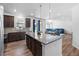 Open concept kitchen with granite counters, stainless steel appliances, island, and view to living area at 1168 Elbridge Dr, Elizabeth, CO 80107