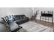 Comfortable living room features a plush sectional sofa and stylish area rug on wood floors at 1168 Elbridge Dr, Elizabeth, CO 80107