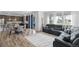 Open-concept living space with dark kitchen cabinetry, dining area, and comfy sectional sofa at 1168 Elbridge Dr, Elizabeth, CO 80107