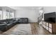 Comfortable living room featuring a large sectional sofa, neutral rug and modern decor at 1168 Elbridge Dr, Elizabeth, CO 80107