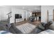 Spacious living area boasts open layout to kitchen, plush sofa, and modern decor at 1168 Elbridge Dr, Elizabeth, CO 80107
