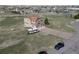Home with a three-car garage and long driveway, along with an RV, set on a grassy lot at 40900 Red Fox Cir, Elizabeth, CO 80107